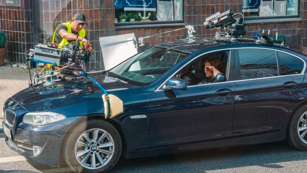 Tenet BTS: IMAX camera rigged to the hood of BMW. Source: IMDB. Credit: Unknown
