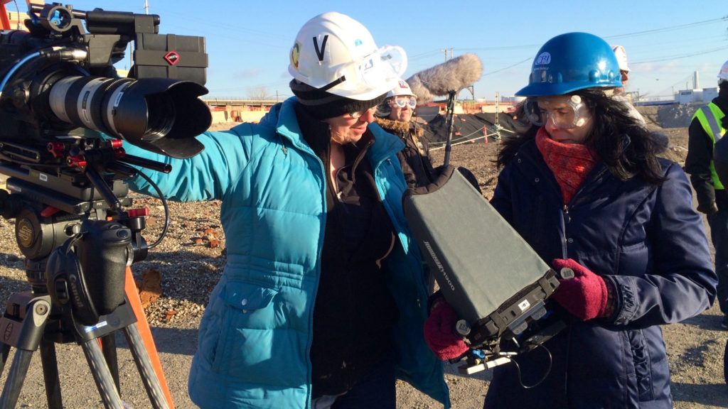 DP Claudia Raschke with director Rebecca Cammisa filming on radio active excavation sight. Photo by Larissa Bills